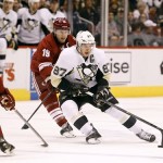  Pittsburgh Penguins' Sidney Crosby (87) skates with the puck around the defense of Phoenix Coyotes' Shane Doan (19) during the first period of an NHL hockey game on Saturday, Feb. 1, 2014, in Glendale, Ariz. (AP Photo/Ralph Freso)