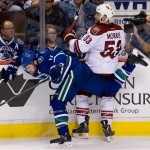 Vancouver Canucks' Alex Burrows, left, and Phoenix Coyotes' Derek Morris collide during the second period of an NHL hockey game in Vancouver, British Columbia, on Monday April 8, 2013. (AP Photo/The Canadian Press, Darryl Dyck)