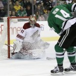  Phoenix Coyotes' Mike Smith (41) deflects a shot from Dallas Stars' Jamie Benn (14) in the first period of an NHL hockey game, Saturday, Feb. 8, 2014, in Dallas. (AP Photo/Tony Gutierrez)