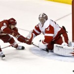 Phoenix Coyotes' Rob Klinkhammer, left, gets his shot kicked away by Detroit Red Wings' Jimmy Howard in the third period during an NHL hockey game on Thursday, April 4, 2013, in Glendale, Ariz. The Coyotes defeated the Red Wings 4-2. (AP Photo/Ross D. Franklin)