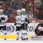  Dallas Stars' Shawn Horcoff (10) celebrates his goal scored against Phoenix Coyotes' Mike Smith, right, with teammates Cody Eakin, second from left, and Rich Peverley, left, during the second period of an NHL hockey game Tuesday, Feb. 4, 2014, in Glendale, Ariz. (AP Photo/Ross D. Franklin)