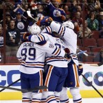 Edmonton Oilers' Lennart Petrell, middle, of Finland, celebrates his goal against the Phoenix Coyotes with teammates, including Sam Gagner (89), during the first period in an NHL hockey game Wednesday, Jan. 30, 2013, in Glendale, Ariz. (AP Photo/Ross D. Franklin)