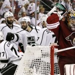 As Phoenix Coyotes goalie Mike Smith, far right, sprays water on his neck, Los Angeles Kings' Drew Doughty (8) celebrates with Rob Scuderi (7), Dustin Penner (25) and Jeff Carter (77) after a goal by Carter in the second period during Game 2 of the NHL hockey Stanley Cup Western Conference finals, Tuesday, May 15, 2012, in Glendale, Ariz. (AP Photo/Ross D. Franklin)