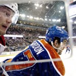  Phoenix Coyotes' Shane Doan (19) is checked by Edmonton Oilers' Boyd Gordon (27) during the first period of an NHL hockey game Friday, Jan. 24, 2014, in Edmonton, Alberta. (AP Photo/The Canadian Press, Jason Franson)