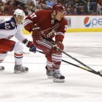 Columbus Blue Jackets' Jared Boll (40) and Phoenix Coyotes' Raffi Torres (37) battle for the puck during the first period of an NHL hockey game, Saturday, Feb. 16, 2013, in Glendale, Ariz. (AP Photo/Matt York)
