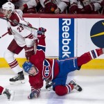 Montreal Canadiens' Brendan Gallagher falls after running into Phoenix Coyotes' Oliver Ekman-Larsson during the first period of an NHL hockey game Tuesday, Dec. 17, 2013, in Montreal. (AP Photo/The Canadian Press, Paul Chiasson)
