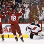  Phoenix Coyotes' David Moss (18) and Mike Ribeiro (63) celebrate a goal scored by teammate Jeff Halpern against New Jersey Devils' Martin Brodeur, right, during the first period of an NHL hockey game on Saturday, Jan. 18, 2014, in Glendale, Ariz. (AP Photo/Ross D. Franklin)