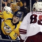 Nashville Predators left wing Gabriel Bourque (57) and Phoenix Coyotes right wing Mikkel Boedker (89), of Denmark, watch a rebound bounce by in the second period of an NHL hockey game, Thursday, Feb. 14, 2013, in Nashville, Tenn. (AP Photo/Mark Humphrey)