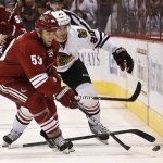 Phoenix Coyotes' Derek Morris (53) gets the puck as Chicago Blackhawks' Brandon Saad (20) loses his stick during the first period in an NHL hockey game Thursday, Feb. 7, 2013, in Glendale, Ariz.(AP Photo/Ross D. Franklin)