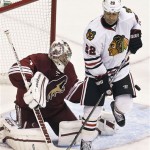 Chicago Blackhawks' Jamal Mayers (22) deflects the puck as Phoenix Coyotes goalie Jason LaBarbera (1) tries to make the save during the third period in an NHL hockey game, Thursday, Feb. 7, 2013, in Glendale, Ariz. The Blackhawks won 6-2. (AP Photo/Ross D. Franklin)