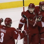 Phoenix Coyotes right wing Radim Vrbata (17) celebrates with Oliver Ekman-Larsson (23) and Keith Yandle (3) after scoring a third period goal against the San Jose Sharks during an NHL hockey game on Friday, Dec. 27, 2013, in Glendale, Ariz. (AP Photo/Rick Scuteri)
