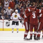 Phoenix Coyotes' Keith Yandle (3) celebrates his goal against the Chicago Blackhawks with teammates Oliver Ekman-Larsson, second from right, Shane Doan, right, and Mikkel Boedker, left, during the first period in an NHL hockey game, Friday Feb. 7, 2014, in Glendale, Ariz. (AP Photo/Ross D. Franklin)