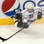 Los Angeles Kings right wing Dustin Brown (23) passes the puck against the Phoenix Coyotes in the second period during an NHL hockey game Saturday, Jan. 26, 2013, in Glendale, Ariz. (AP Photo/Rick Scuteri)

