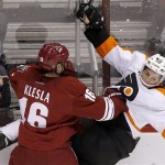 Phoenix Coyotes' Rostislav Klesla (16), of the Czech Republic, checks Philadelphia Flyers' Vincent Lecavalier (40) into the boards during the third period of an NHL hockey game Saturday, Jan. 4, 2014, in Glendale, Ariz. The Flyers defeated the Coyotes 5-3. (AP Photo/Ross D. Franklin)
