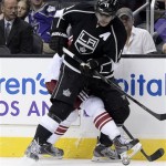 Los Angeles Kings center Anze Kopitar, front, controls the puck against Gilbert Brule, back, of the Phoenix Coyotes a during the second period of an NHL hockey game at the Staples Center Sunday, April 15, 2013., in Los Angeles. (AP Photo/Kevork Djansezian)