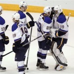 St Louis Blues goaltender Ryan Miller (39) is congratulated by teammates Steve Ott (29), Patrick Burglund, of Sweden, top center, Jay Bouwmeester (19) and Carlo Colaiacovo (13) following a 4-2 victory over the Phoenix Coyotes on Sunday, March 2, 2014, in Glendale, Ariz. Miller made his debut in goal with the Blues after being traded from the Buffalo Sabres. (AP Photo/Ralph Freso)