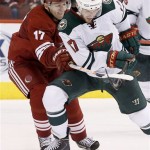 Phoenix Coyotes' Radim Vrbata, left, of the Czech Republic, battles Minnesota Wild's Torrey Mitchell for the puck during the third period in an NHL hockey game Thursday, Jan. 9, 2014, in Glendale, Ariz. The Wild defeated the Coyotes 4-1. (AP Photo/Ross D. Franklin)
