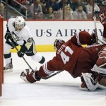  Phoenix Coyotes goaltender Mike Smith (41) makes a diving glove save on the shot by Pittsburgh Penguins' Brian Gibbons (49) during the first period of an NHL hockey game on Saturday, Feb. 1, 2014, in Glendale, Ariz. (AP Photo/Ralph Freso)