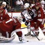 Phoenix Coyotes goalie Jason LaBarbera (1) makes a save on a shot by Columbus Blue Jackets' Artem Anisimov (42), of Russia, as Coyotes' Derek Morris (53) defends during the second period in an NHL hockey game, Wednesday, Jan. 23, 2013, in Glendale, Ariz. (AP Photo/Ross D. Franklin)