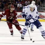 Toronto Maple Leafs left wing James van Riemsdyk (21) carries the puck past Phoenix Coyotes center Antoine Vermette (50) in the first period of an NHL hockey game, Monday, Jan. 20, 2014, in Glendale, Ariz. (AP Photo/Rick Scuteri)