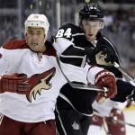 Phoenix Coyotes' Brandon Yip (32) and Los Angeles Kings' Derek Forbort (84) battle for the puck during the first period of an NHL preseason hockey game at the Staples Center, Sunday, Sept. 15, 2013, in Los Angeles. (AP Photo/Kevork Djansezian)