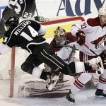 Los Angeles Kings' Justin Williams (14) falls to ice in front of Phoenix 
Coyotes goalie Mike Smith, center, and Oliver Ekman-Larsson, of 
Sweden, during the first period of Game 4 of the NHL hockey Stanley 
Cup Western Conference finals in Los Angeles, Sunday, May 20, 2012. 
(AP Photo/Jae C. Hong)
