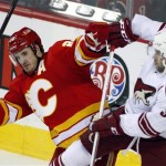 Phoenix Coyotes' Keith Yandle, right, and Calgary Flames' Curtis Glencross collide during the first period of an NHL hockey game in Calgary, Alberta, Sunday, Feb. 24, 2013. (AP Photo/The Canadian Press, Jeff McIntosh)