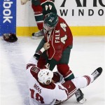Minnesota Wild defenseman Justin Falk (44) fights with Phoenix Coyotes left wing David Moss (18) during the first period of an NHL hockey game Wednesday, March 27, 2013, in St. Paul, Minn. (AP Photo/Genevieve Ross)