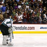 San Jose Sharks' Antti Niemi, of Finland, pauses as fans stand in the background for a moment of silence for the victims of the bombing at the Boston Marathon prior to an NHL hockey game between the Sharks and the Phoenix Coyotes, on Monday, April 15, 2013 in Glendale, Ariz. (AP Photo/Ross D. Franklin)