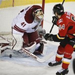  Phoenix Coyotes goalie Mike Smith, left, stops a shot from Calgary Flames' David Jones during first period NHL hockey action in Calgary, Canada, Wednesday, Jan. 22, 2014. (AP Photo/The Canadian Press, Jeff McIntosh)