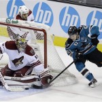 Phoenix Coyotes goalie Mike Smith stops a shot on goal by San Jose Sharks center Tommy Wingels (57) during overtime of an NHL hockey game in San Jose, Calif., Saturday, Feb. 9, 2013. Phoenix won 1-0 in a shootout. (AP Photo/Marcio Jose Sanchez)
