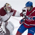 Phoenix Coyotes goalie Mike Smith fends off Montreal Canadiens' David Desharnais during the third period of an NHL hockey game Tuesday, Dec. 17, 2013, in Montreal. (AP Photo/The Canadian Press, Paul Chiasson)