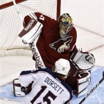 Phoenix Coyotes' Mike Smith, top, makes a save on a shot by Columbus Blue Jackets' Derek Dorsett (15) during the first period in an NHL hockey game on Wednesday, Jan. 23, 2013, in Glendale, Ariz. (AP Photo/Ross D. Franklin)