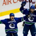 Vancouver Canucks' Kevin Bieksa, left, and Brad Richardson celebrate Bieksa's winning goal against the Phoenix Coyotes during the third period of an NHL hockey game in Vancouver, British Columbia, on Sunday, Jan. 26, 2014. (AP Photo/The Canadian Press, Darryl Dyck)