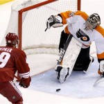 Philadelphia Flyers' Steve Mason (35) gives up a goal to Phoenix Coyotes' Rob Klinkhammer as Coyotes' Mikkel Boedker (89), of Denmark, watches during the second period of an NHL hockey game Saturday, Jan. 4, 2014, in Glendale, Ariz. (AP Photo/Ross D. Franklin)