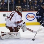 Phoenix Coyotes' goaltender Mike Smith (41) watches Winnipeg Jets' Blake Wheeler (26) pounce on a rebound and bury it into the open net during second period NHL hockey action in Winnipeg, Canada, Monday, Jan. 13, 2014. (AP Photo/The Canadian Press, Trevor Hagan)