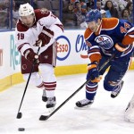  Phoenix Coyotes' Shane Doan (19) and Edmonton Oilers' Corey Potter (44) race for the puck during the first period of an NHL hockey game Friday, Jan. 24, 2014, in Edmonton, Alberta. (AP Photo/The Canadian Press, Jason Franson)