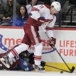 Phoenix Coyotes center Martin Hanzal, of Czech Republic, (11) works against Colorado Avalanche defenseman Cory Sarich (16) for a loose puck during the first period of an NHL hockey game in Denver on Tuesday, Dec. 10, 2013. (AP Photo/Joe Mahoney)