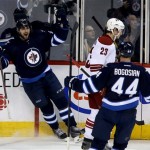 Winnipeg Jets' Eric O'Dell (58) celebrates after scoring with Zach Bogosian (44) as Phoenix Coyotes' Oliver Ekman-Larsson (23) looks on during first period NHL hockey action in Winnipeg, Canada, Monday, Jan. 13, 2014. (AP Photo/The Canadian Press, Trevor Hagan)