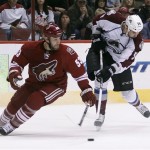 Colorado Avalanche left winger Patrick Bordeleau, right, attempts a shot as Phoenix Coyotes defenseman Derek Morris, left, spins around to defend in the first period of NHL hockey game, Saturday, April 6, 2013, in Glendale, Ariz. (AP Photo/Paul Connors)
