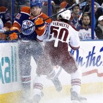  Phoenix Coyotes' Antoine Vermette (50) checks Edmonton Oilers' Andrew Ference (21) during the first period of an NHL hockey game Friday, Jan. 24, 2014, in Edmonton, Alberta. (AP Photo/The Canadian Press, Jason Franson)