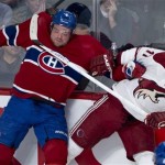 Montreal Canadiens' Douglas Murray and Phoenix Coyotes' Martin Hanzal crash into the boards during the second period of an NHL hockey game Tuesday, Dec. 17, 2013, in Montreal. (AP Photo/The Canadian Press, Paul Chiasson)