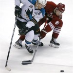 San Jose Sharks' Patrick Marleau (12) battles Phoenix Coyotes' Mikkel Bodker (89) for the puck during the second period of an NHL hockey game on Wednesday, April 24, 2013, in Glendale, Ariz. (AP Photo/Matt York)