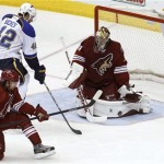 Phoenix Coyotes goaltender Mike Smith (41) makes a pad save in front of St Louis Blues' David Backes (42) as Coyotes' David Schlemko (6) looks to clear the puck during the second period of an NHL hockey game on Sunday, March 2, 2014, in Glendale, Ariz. (AP Photo/Ralph Freso)
