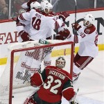 
Phoenix Coyotes players celebrate after Coyotes center Boyd Gordon scored on Minnesota Wild goalie Niklas Backstrom (32), of Finland, during the second period of an NHL hockey game Wednesday, March 27, 2013, in St. Paul, Minn. (AP Photo/Genevieve Ross)