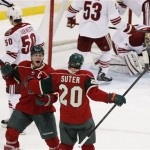 Minnesota Wild center Mikko Koivu, left, of Finland, celebrates with teammate Ryan Suter (20) after scoring in overtime on Phoenix Coyotes goalie Jason LaBarbera, top right, in an NHL hockey game Wednesday, March 27, 2013, in St. Paul, Minn. The Wild won 4-3. (AP Photo/Genevieve Ross)