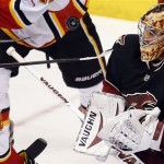 Phoenix Coyotes goalie Mike Smith makes a save against the Calgary Flames during the second period of an NHL hockey game, Tuesday, Jan. 7, 2014, in Glendale, Ariz. (AP Photo/The Arizona Republic, Michael Chow)