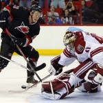Phoenix Coyotes goalie Mike Smith (41) kicks the shot of Carolina Hurricanes' Jeff Skinner (53) away from the net during the second period of an NHL hockey game, Sunday, Oct. 13, 2013, in Raleigh, N.C. (AP Photo/Karl B DeBlaker)