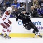Los Angeles Kings Valentine Zykov, right, attempts to control the puck against Phoenix Coyotes James Melindy during the second period of an NHL hockey game at the Staples Center Sunday, April 15, 2013., in Los Angeles. (AP Photo/Kevork Djansezian)