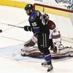 Phoenix Coyotes' Mike Smith (41) gets shielded by Los Angeles Kings' Dustin Penner (25) as Kings' Mike Richards scores a goal in the second period of an NHL hockey game Tuesday, March 12, 2013, in Glendale, Ariz. (AP Photo/Ross D. Franklin)